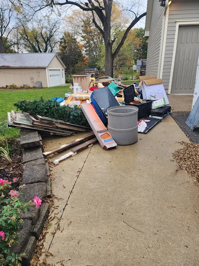 Dumpster being loaded with debris for Estate Cleanout Dumpster Rental in Glen Rose